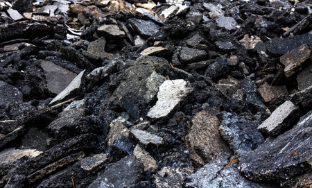 Isolates background ensemble pieces of asphalt road which lay heaped on the ground to be recycled.の写真素材