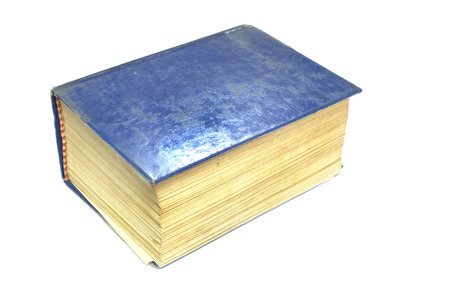 Old thick book blue cover on white background.の写真素材