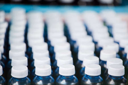 Lots of bottle with white lid with selective focus.の写真素材