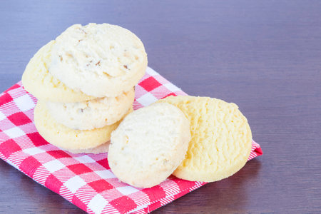 Cookie on plaid with wooden table background with copyspace