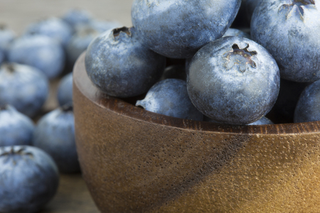Blueberries in wooden bowl on wooden table copyspaceの写真素材
