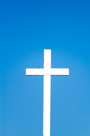 cross against the blue sky backgroundの写真素材
