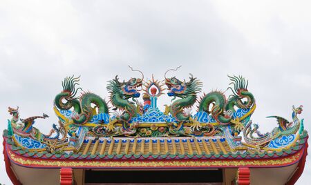 Dragons statue on the roof of Chinese temple, Suphanburi, Thailand の写真素材