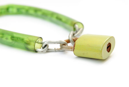 Metal padlock with key and chain on white background
