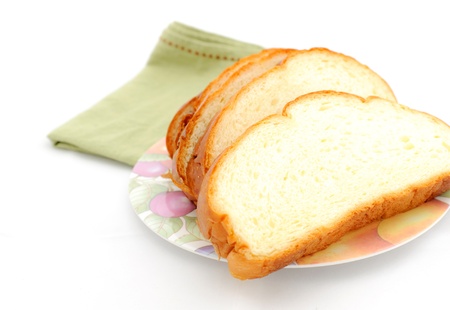 Slice of bread on the plate with white backgroundの写真素材