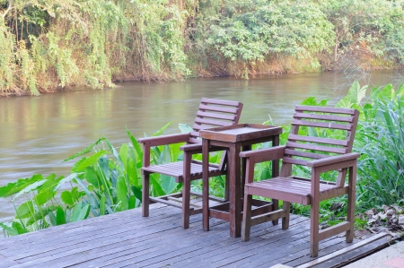 Two chair on wooden floor beside the river の写真素材