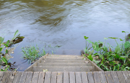 Wooden stairs way down the river  の写真素材