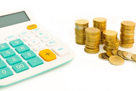 Saving money plan and calculator,stacl of coins with white backgroundの写真素材