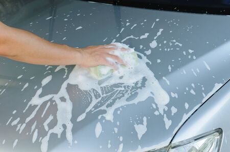 Car Hand Wash with Yellow Sponge and Soap, Car silverの写真素材
