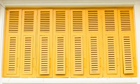 Thai old style classic wood window in yellow colorの写真素材