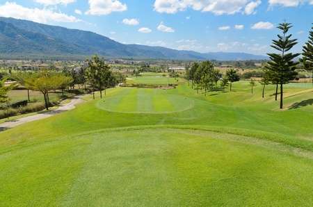 Beautiful golf course in the hill with blue sky backgroundの写真素材