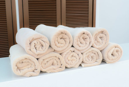 Brown towels roll neatly for pool side use