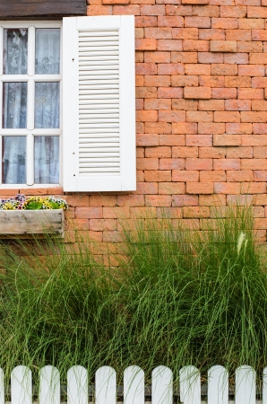 Window with brick wall red backgroundの写真素材