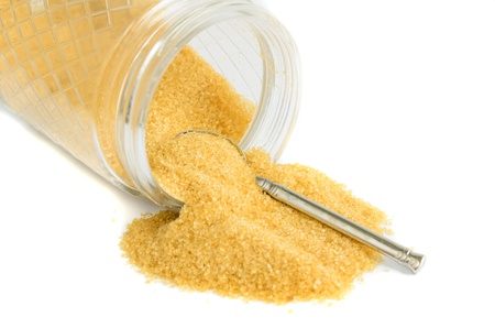 Granulated sugar in jar against a white backgroundの写真素材