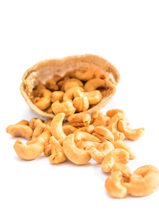 Cashew nuts in a sack with isolated white の写真素材