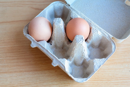 Eggs in paper tray on wooden 