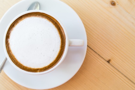 Cappuccino Coffee on wooden table backgroundの写真素材