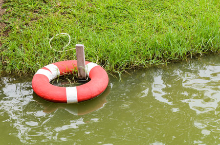 Red lifebuoy in water