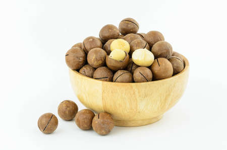 Macadamia Nuts  in wooden bowl on white backgroundの写真素材