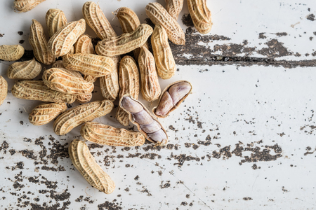 Peanuts on white wooden tableの写真素材