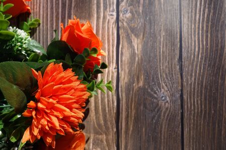 Bouquet of orange flowers on wooden background with copy spaceの写真素材