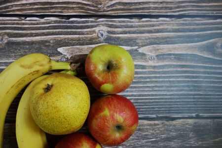 Raw fruits on wooden background, space for your designの写真素材