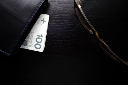 Savings under a purse on a desk, financial conceptの写真素材
