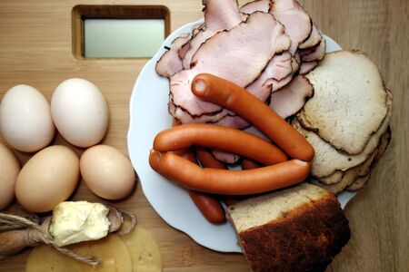 Fatty food on a bathroom scale, overweight and obesity conceptの写真素材