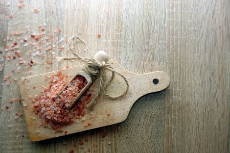 Pink himalayan salt on wooden table, overhead view, background with copy spaceの写真素材