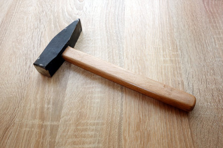 Old wooden hammer with a metal head