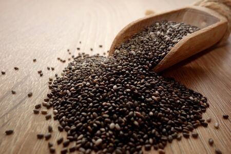Healthy chia seeds in a wooden scoop on table, close-upの写真素材