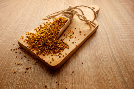 Scoop of bee pollen on wooden background, copy space for your text or objectの写真素材