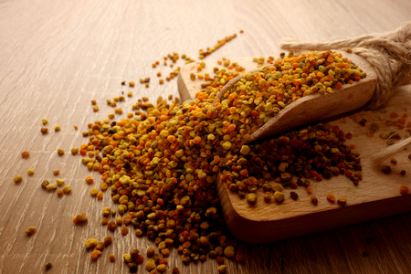 Bee pollen on wooden background, close-upの写真素材