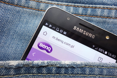 KONSKIE, POLAND - MAY 17, 2018: Benq website is displayed on Samsung smartphone hidden in jeans pocketのeditorial素材