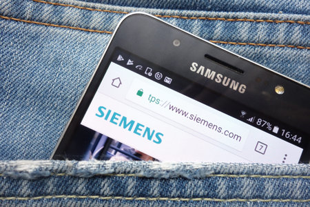 KONSKIE, POLAND - MAY 17, 2018: Siemens website displayed on Samsung smartphone hidden in jeans...