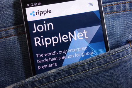 KONSKIE, POLAND - MAY 17, 2018: Ripple website displayed on smartphone hidden in jeans pocketのeditorial素材