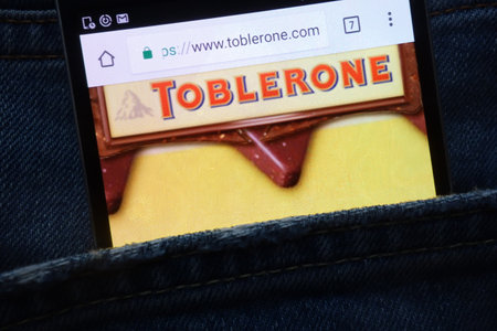 KONSKIE, POLAND - MAY 18, 2018: Toblerone website displayed on smartphone hidden in jeans pocketのeditorial素材