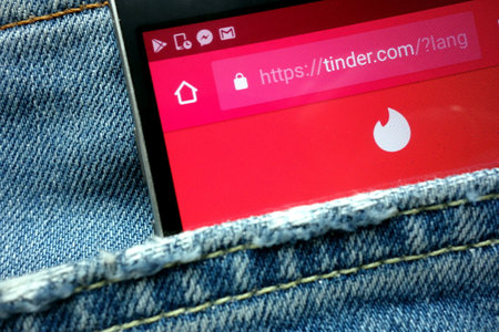 KONSKIE, POLAND - JUNE 01, 2018: Tinder website displayed on smartphone hidden in jeans pocketのeditorial素材