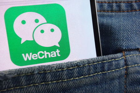 KONSKIE, POLAND - JUNE 01, 2018: WeChat logo displayed on smartphone hidden in jeans pocketのeditorial素材