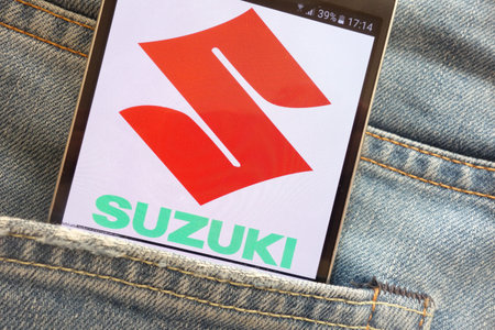 KONSKIE, POLAND - JUNE 02, 2018: Suzuki Motor Corporation logo displayed on smartphone hidden in...