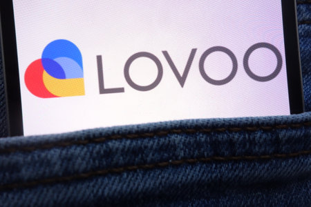 KONSKIE, POLAND - JUNE 11, 2018: Lovoo logo displayed on smartphone hidden in jeans pocketのeditorial素材