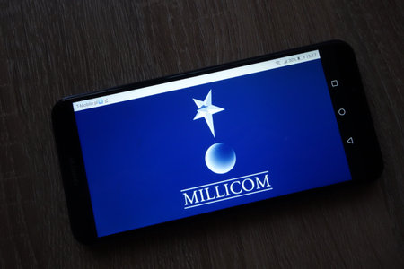 KONSKIE, POLAND - December 01, 2018: Millicom International Cellural SA logo displayed on smartphoneのeditorial素材