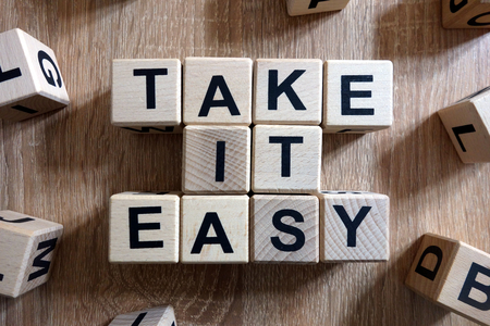 Take it easy text from wooden blocks on deskの写真素材