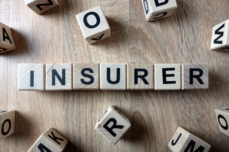 Insurer word from wooden blocks on deskの写真素材