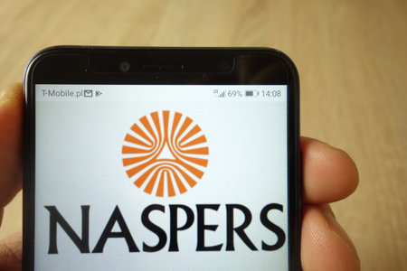 KONSKIE, POLAND - May 18, 2019: hand holding smartphone with Naspers company logo displayed on screenのeditorial素材