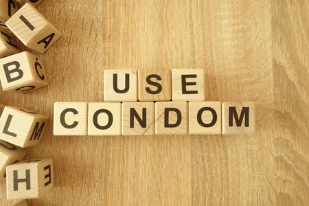 Text use condom from wooden blocks on desk backgroundの写真素材