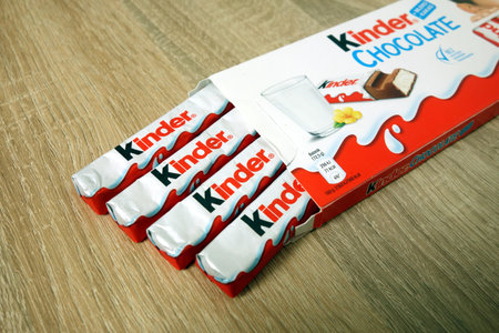 KONSKIE, POLAND - June 21, 2019: Kinder Chocolate on wooden table background