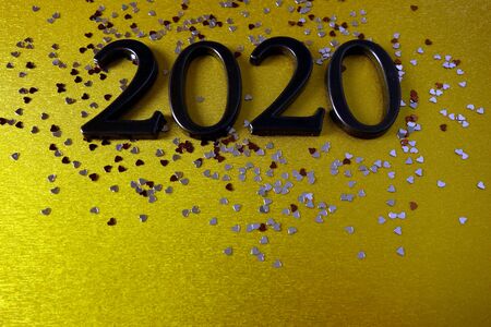 Number 2020 with ornaments on shiny yellow background, Happy New Year concept, copy space for your designの写真素材