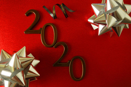 New Year 2020 party concept, number 2020 and ornaments on red background