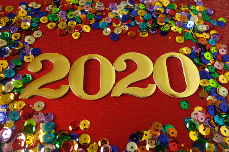 Happy New Year 2020. Symbol from number 2020 on red background with confetti